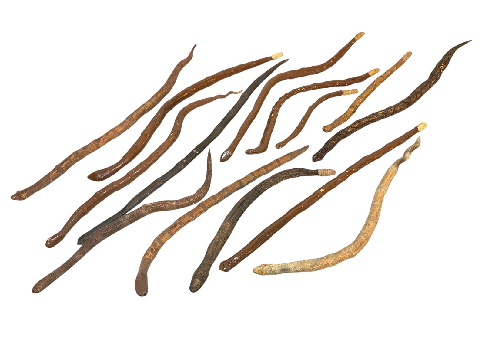 Collection Early 290th C Folk Art Snakes, Texas: Includes an assortment of snakes. The largest measures 30.5" long x 1" diameter, the smallest measures 12.5" long x .5" diameter. All carved from found tree branches