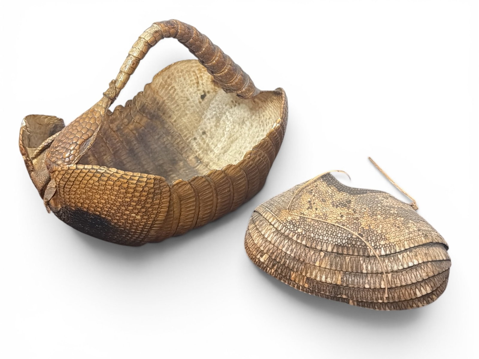 Two Armadillo Shell Taxidermy Baskets, Oddity: Larger basket measures 8" H x 8.5" W x 12" D, the smaller pouch measures 4" H x 7" W x 4" D. Property from the Collection of Marjorie and Harvey Freed.