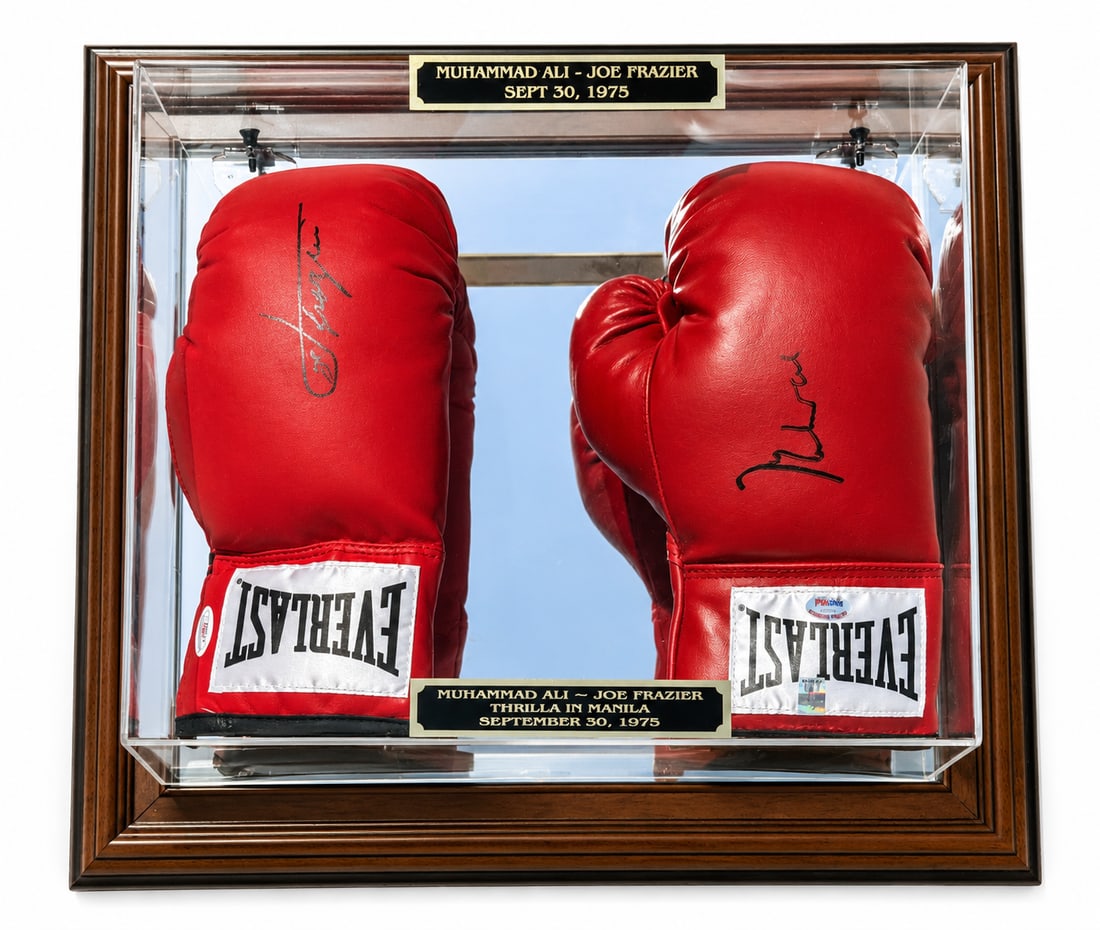 Authentic Autographed MUHAMMAD ALI / JOE FRAZIER Boxing Gloves, PSA and JSA: Two Everlast Boxing gloves signed by Muhammad Ali and Joe Frazier to commemorate their Thrilla in Manilla fight. Entire display measures 18. 5" H x 20. 5" W x 6. 5" D. Ali glove retinas PSA/DNA hologr