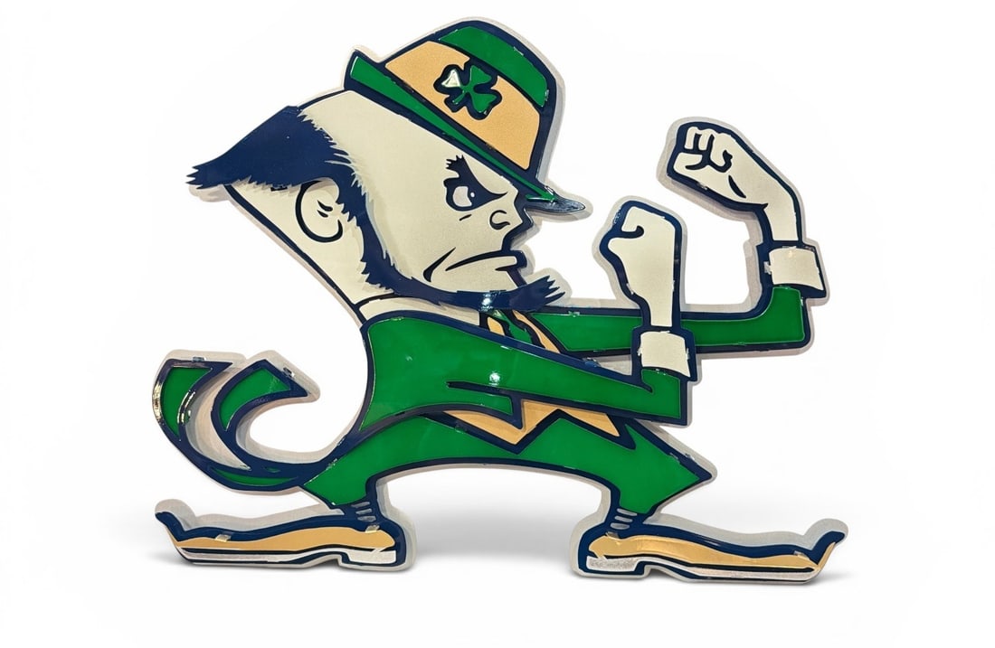 NOTRE DAME Fighting Irish Metal Decorative Sign: Retains a label from Hexheadart en verso. Measures 20" H x 25" W x 2" D.
