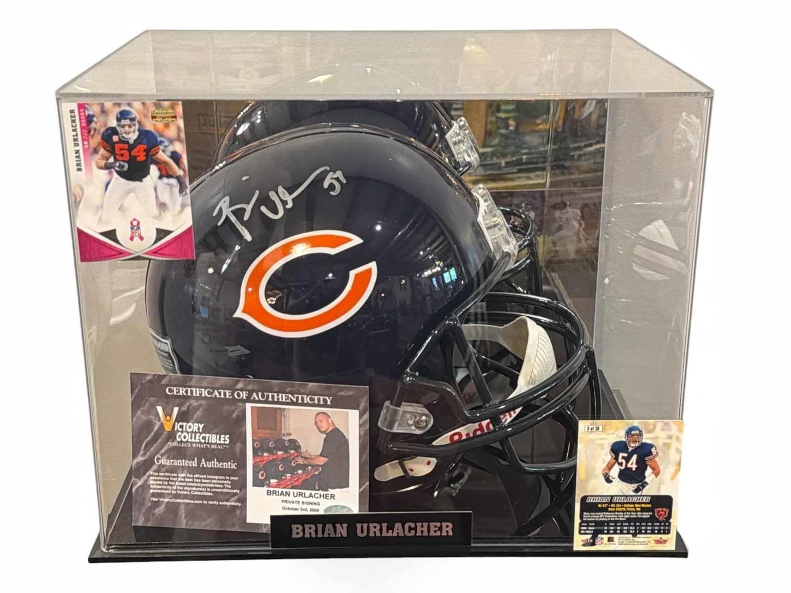 Authentic Autographed BRIAN URLACHER Chicago Bears Football Helmet: Includes signed helmet 89/100 limited edition Victory Collectibles and COA included. 2 Football Cards, FLEER 2001 #2/38 and 2011 PANINI America #24. Case measures 11. 5" H x 14. 25" W x 11" D.