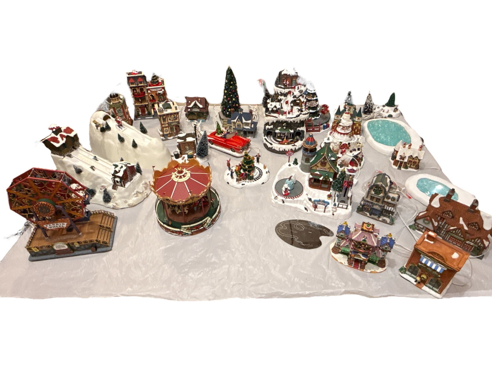 Large Collection Vintage Christmas Village Department 56, LEMAX: Approx. 30 pcs. Some Dept. 56, Lemax and others. Tallest piece 15" H. Comes with numerous assorted cords. This lot is available for pickup or must ship via one of our reliable private carriers.