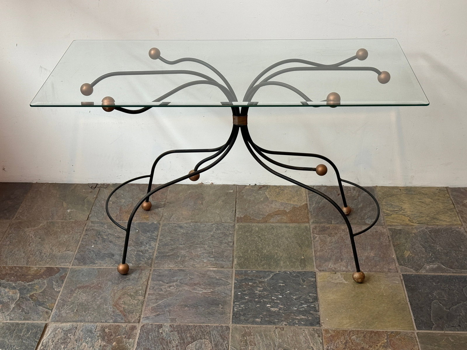 Modernist French Art Deco Console Table: Metal tube base and frame, wood ball accents, bevel glass top. Measures 29" h 48" w X 24" d