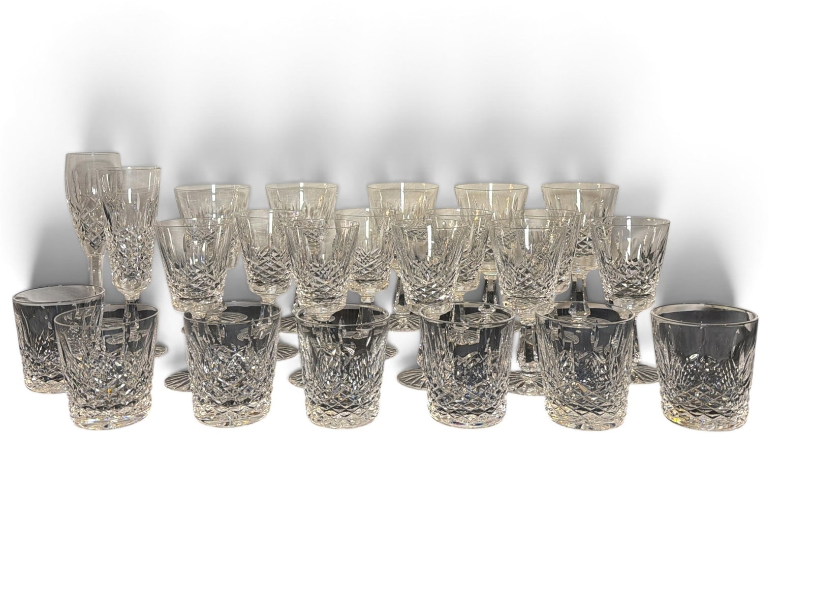 Collection WATERFORD Crystal Glassware: Includes 7 rocks glasses that measures 3.5" H x 3.25" overall diameter, 9 Kenmare wine goblets that measure 6.5" H x 3" overall diameter, 5 Kenmore water goblets that measure 7" H x 3.5" diameter, 1 K