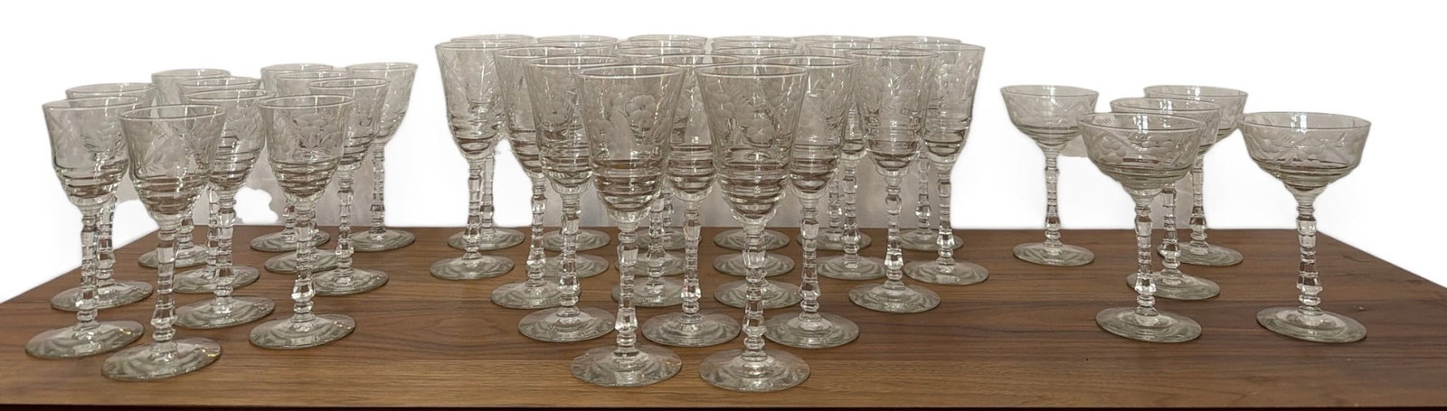 Collection 1940's LIBBEY Rock Sharpe Stemware Glasses: Tallest glass measures 8.75" H x 3.25" diameter, cordial glasses measure 7" H x 2.75" diameter, and coupe glasses measure 6.25" H x 3.75" diameter.