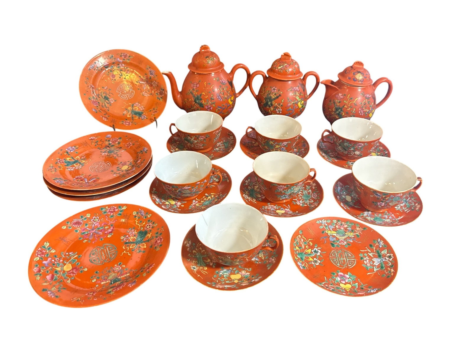 19th C. Late Qing Dynasty Petite Orange Garden Dishware: Porcelain. Circa 1890's -1920. Vibrant orange/red glaze. Plates measure 7.5" diameter. Set includes 5 plates, 7 tea cups, 8 saucers, tea pot, creamer and sugar jar.