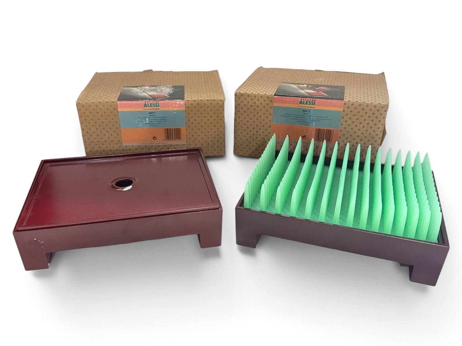 Two PHILIPPE STARCK (French, b.1949) For ALESSI Bakelite Desk Articles: New old stock, retaining original boxes. Includes a "Liberte" letter holder and a "Secrets" box. Boxes measure 5" H x 10" W x 8" D and 4.5" H x 9.75" W x 7.5" D, respectively.