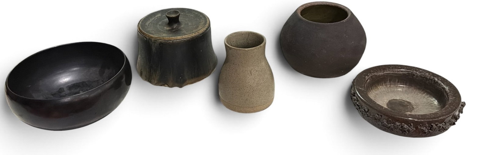 Collection of Mid Century Studio Pottery, MARTZ, TAKASHI WADA: Includes five pieces total; a small vase signed Martz that measures 3.75" H x 3" diameter, a matte black bowl signed Takashi Wada, an artist signed lidded bowl, an Icelandic lava pottery ashtray, and