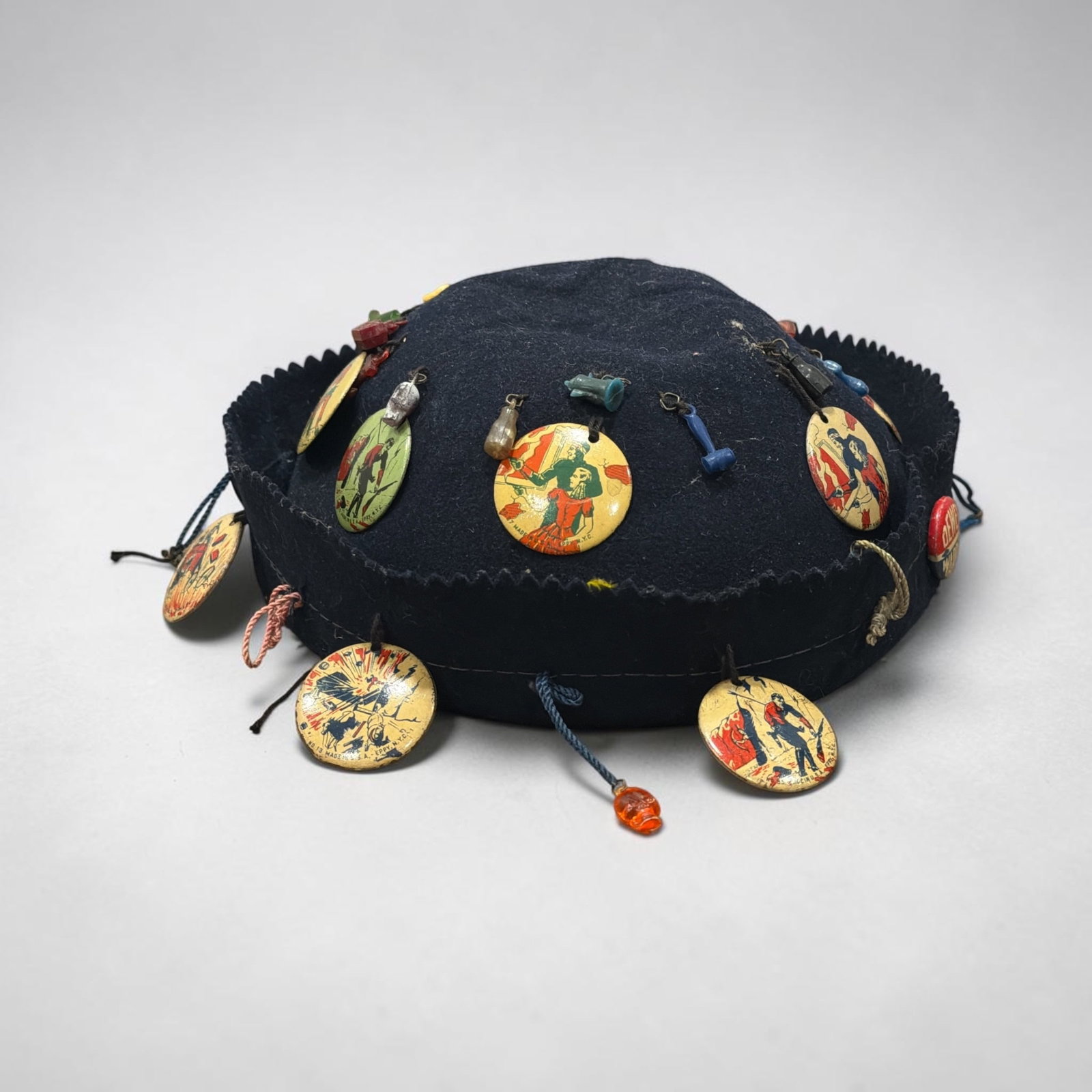 1930's Felt Beanie Hat with Souvenir Pins & Cracker Jack Prizes: Measures approx. 3" H x 7" Diameter. All old as found.