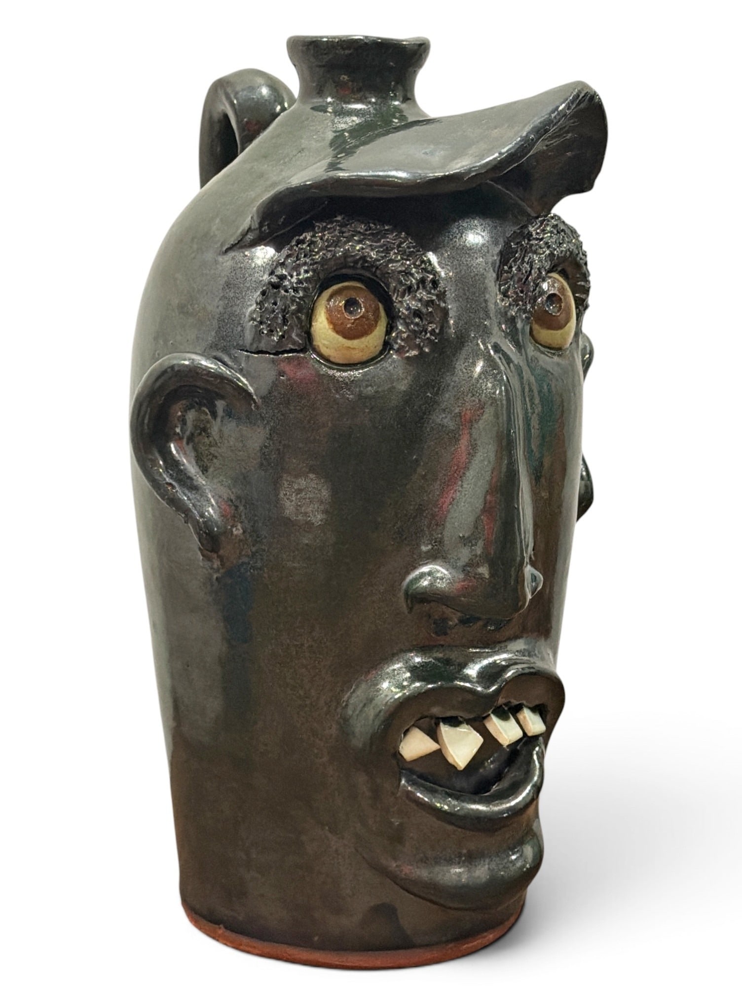 Folk Art Face Jug, BILLY JOE CRAVEN (American/Georgia, b. 1947): Billy Joe Craven is a 9th generation pottery based in Gillsville, Georgia. He focused on functional gardenware before dedicating his time to face jugs. He is widely recognized for distinctive bulging