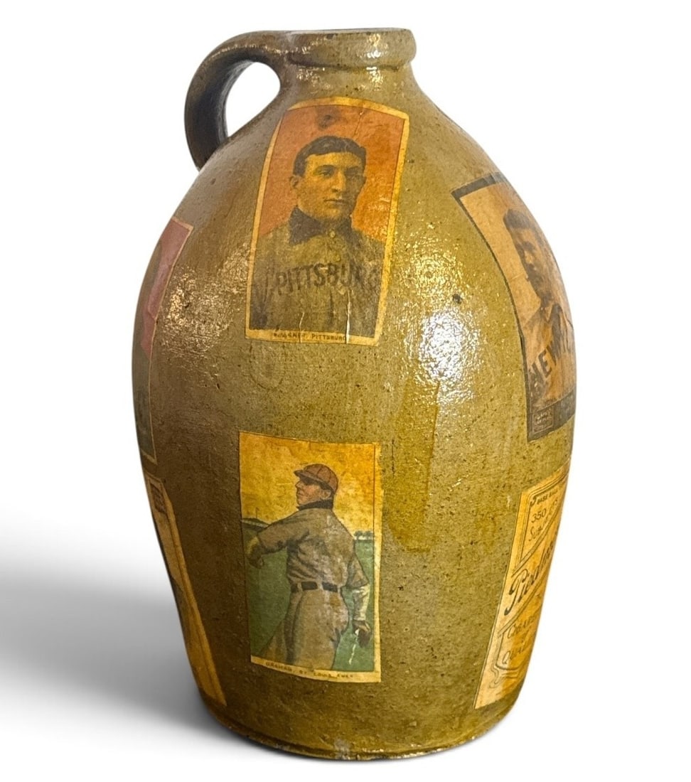 POPS CASEY (American, 20th C.) Folk Art Baseball Card Memory Jug: Measures 12" H x 7" overall diameter. Signed "Pops Casey U. S. A. " on the bottom.