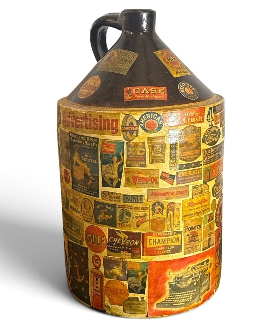 POPS CASEY (American, 20th C.) Large Folk Art Advertising Jug: Features petroliana and automobile advertising logos. Measures 17.5" H x 11" overall diameter. Signed "Pops Casey U. S. A. " on bottom.