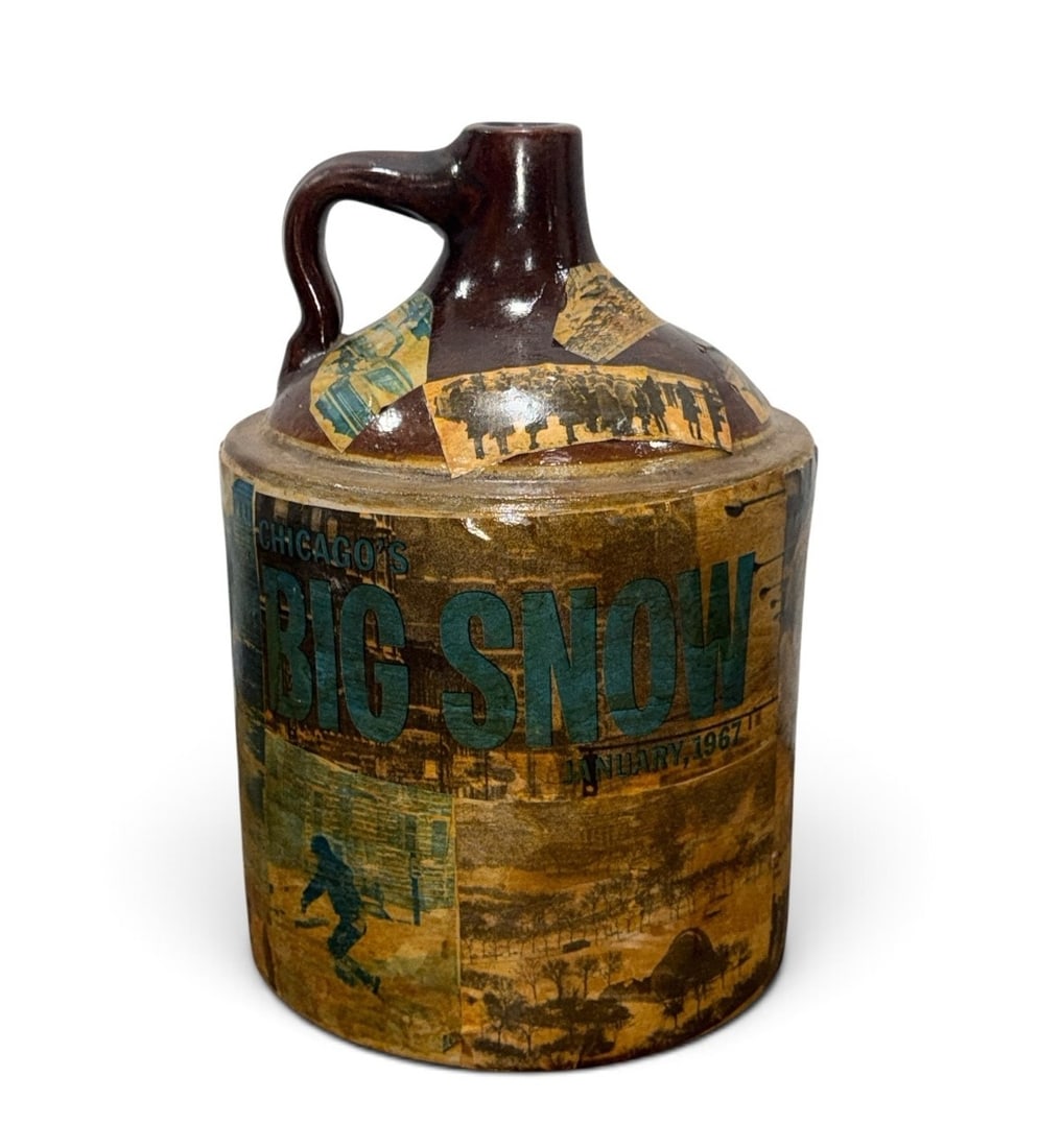 POPS CASEY Folk Art Jug, Chicago Blizzard 1967: Depicting newspaper clippings and photograph prints from the blizzard in Chicago in 1967. Signed Pops Casey, USA on bottom. Measures 13.5" H x 10" overall diameter.