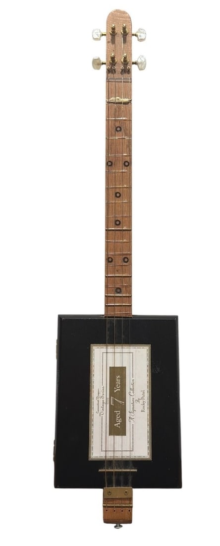 Folk Art Cigar Box Guitar: Measures 28.5" H x 8.5" W x 2" D.