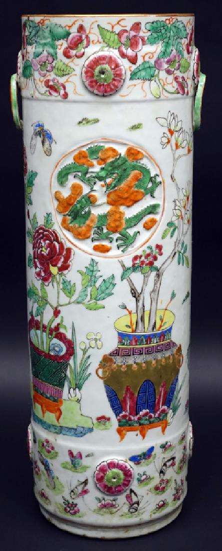 CHINESE EXPORT UMBRELLA STAND: Famille Rose porcelain with relief decoration; painted with birds, dragon, butterfly, and floral motif; part of ring handle missing; 1 1/2" repair to top edge with extending hairline; interior central