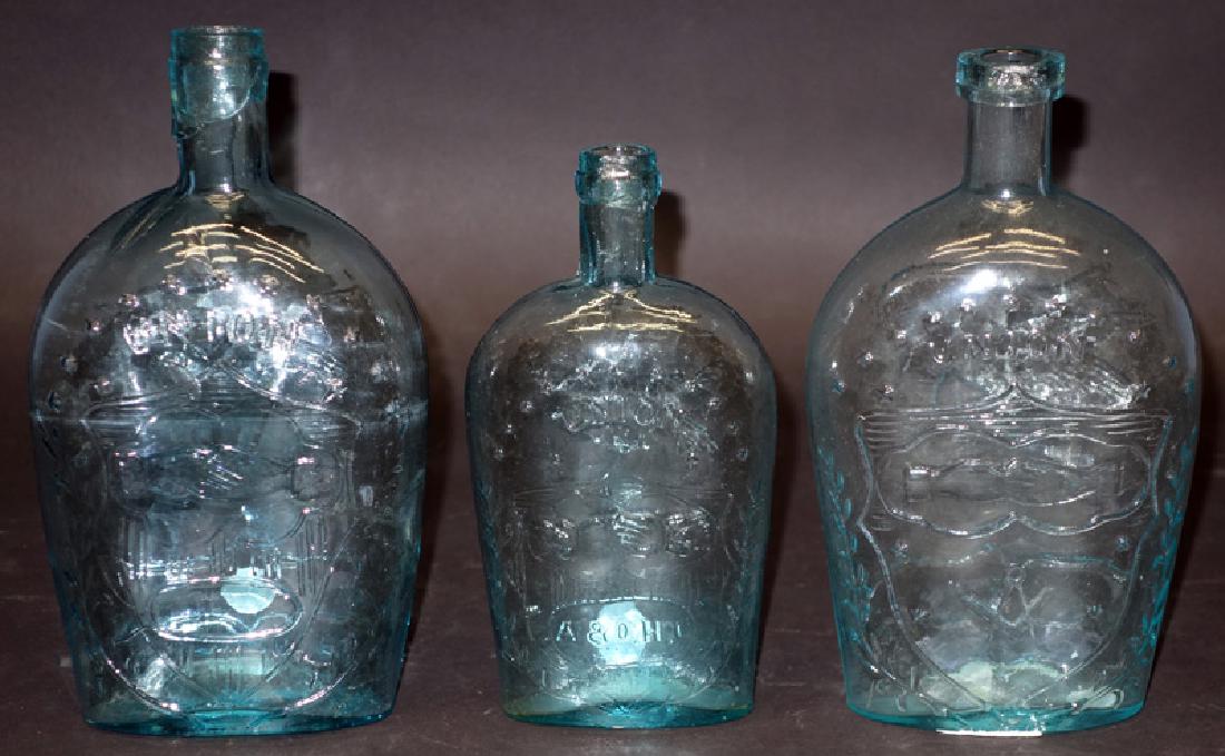 CLASPED HANDS FLASKS (3) "UNION": (1) Pint: aqua, small base, (A&D H. C.) GXII 27; (1) quart: aqua, Mason's (H. S. ) G IV 39; (1) quart: aqua, open oval, small base, G XII 10; all have lip chips; H-7 3/4" - 9", F-G