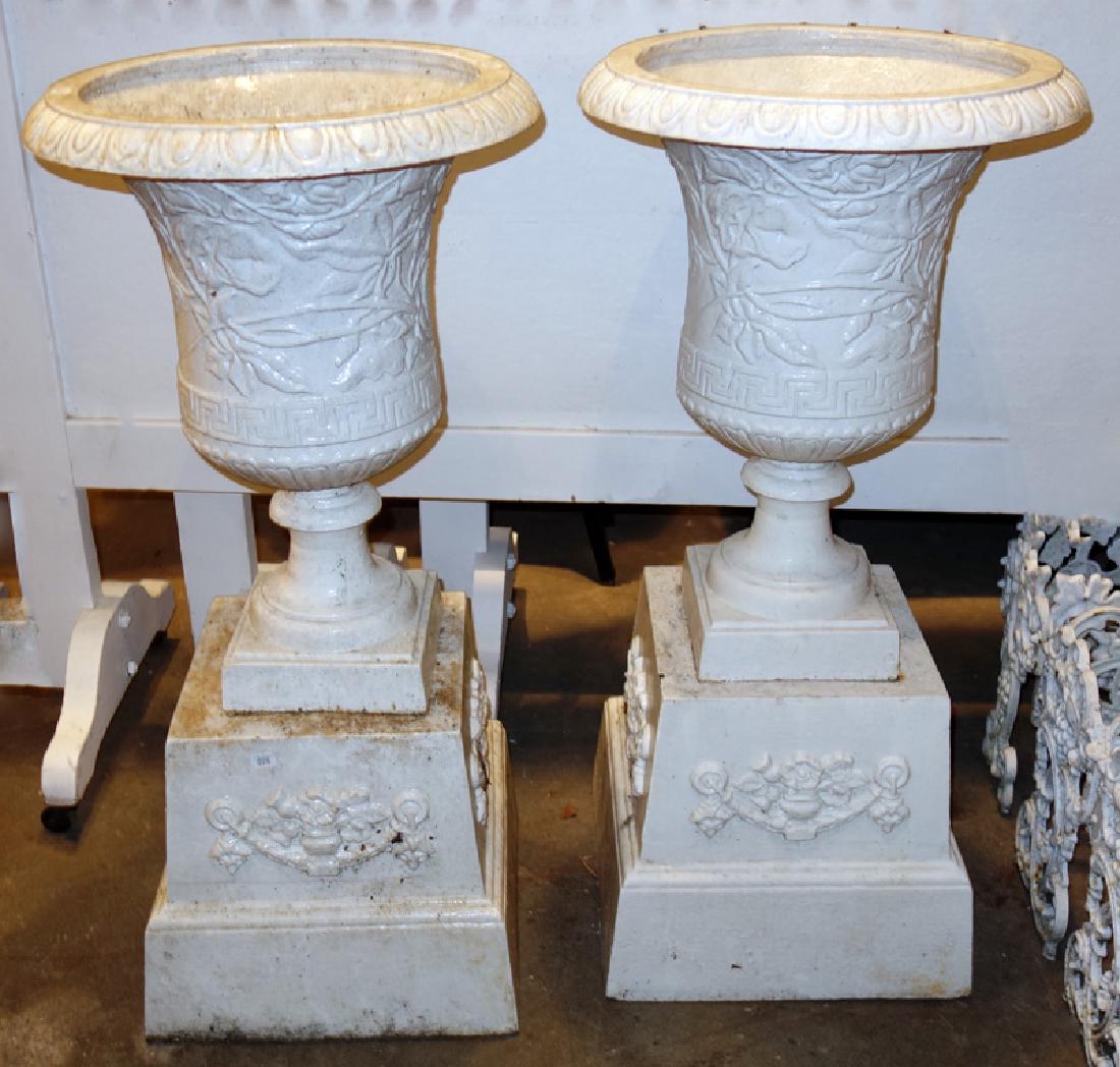 VICTORIAN CAST IRON PLANTERS: Floral and geometric embossed urns on square bases; H-38"