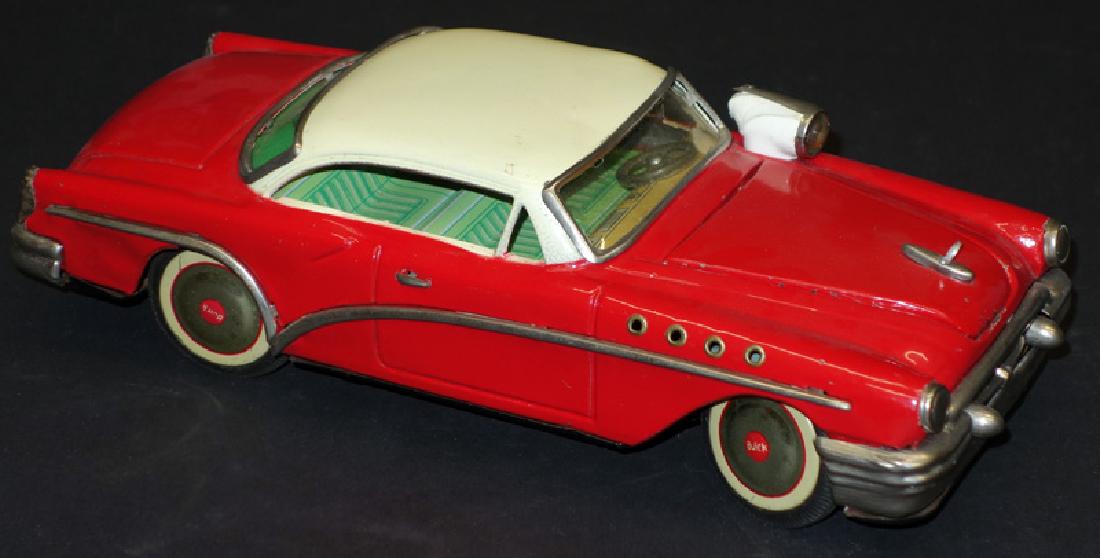 JAPANESE BUICK: Irco; litho and painted tin; battery op; runs and spot lights, hood lifts to expose motor, which does not light; normal wear; some bumper rust; L-10", G-VG