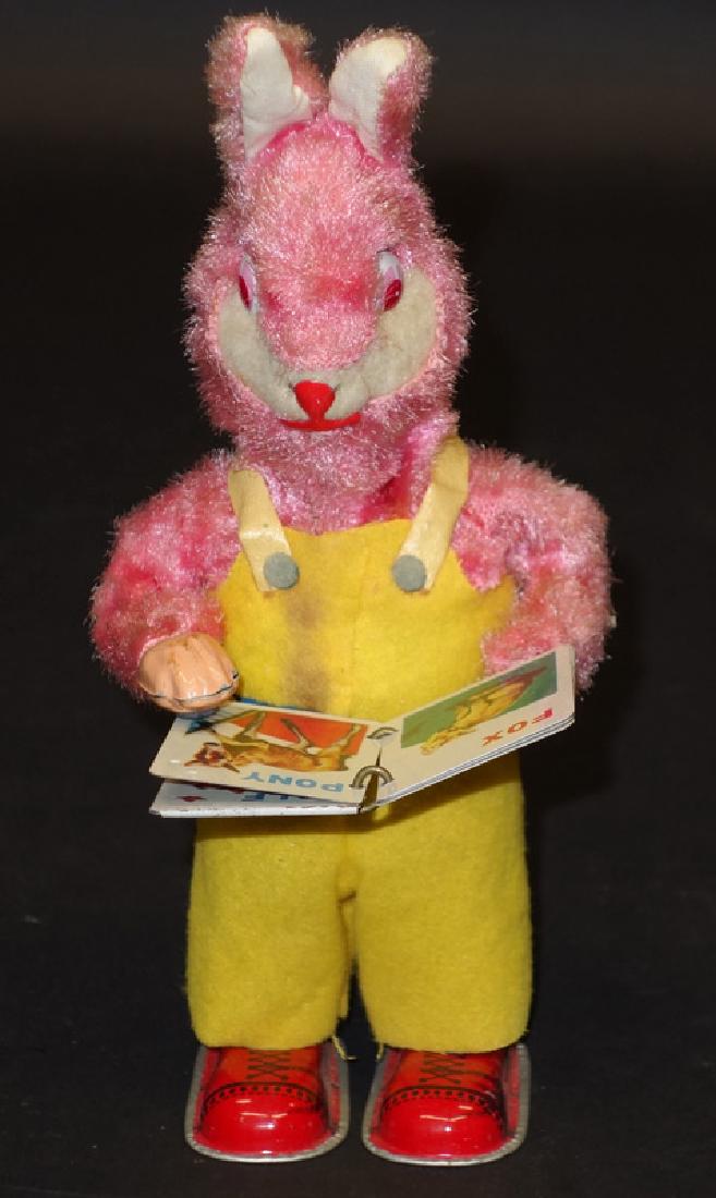 JAPANESE READING RABBIT: Litho tin, plush and cloth; mechanical; working; some soiling; normal wear; H-7 1/2", G-VG