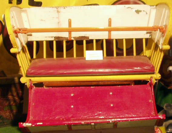 WOOD & IRON FERRIS WHEEL SEAT: Painted wood and iron with vinyl upholstery; repainted; L-48", VG