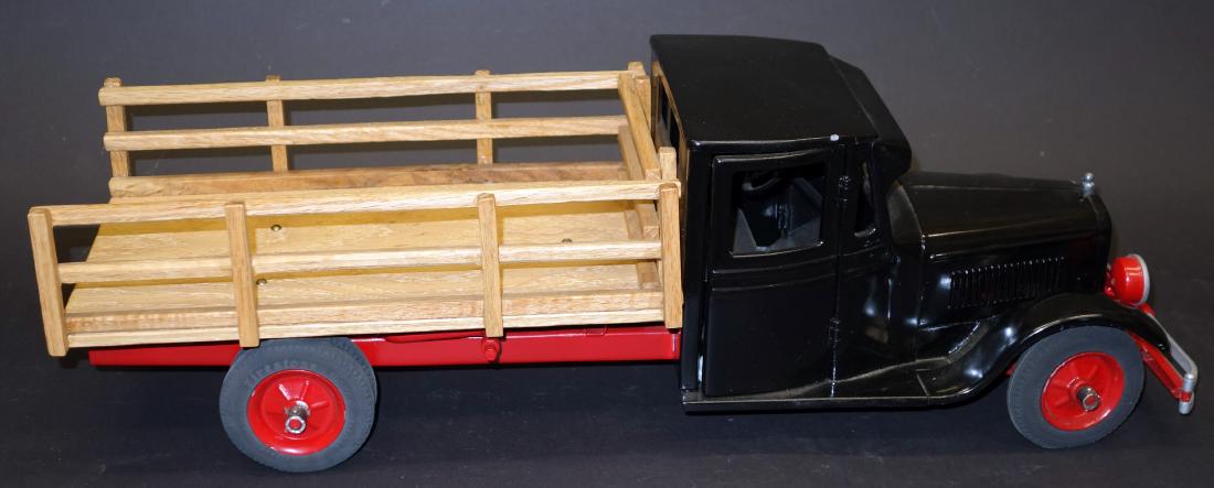 BUDDY L JUNIOR TRUCK: Painted pressed steel with wood stake body; total restoration; L-24", G-VG