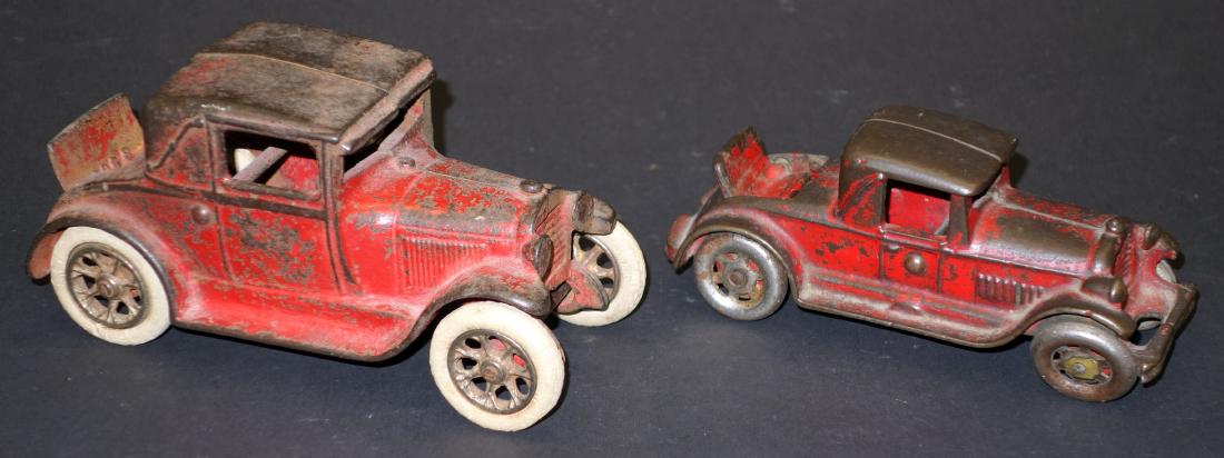 CAST IRON RUMBLE SEAT CARS (2): Painted cast iron; (1) Arcade: missing passenger, rust, paint loss, F; (1) small, paint loss, F; L-5 3/4" - 6 1/2"