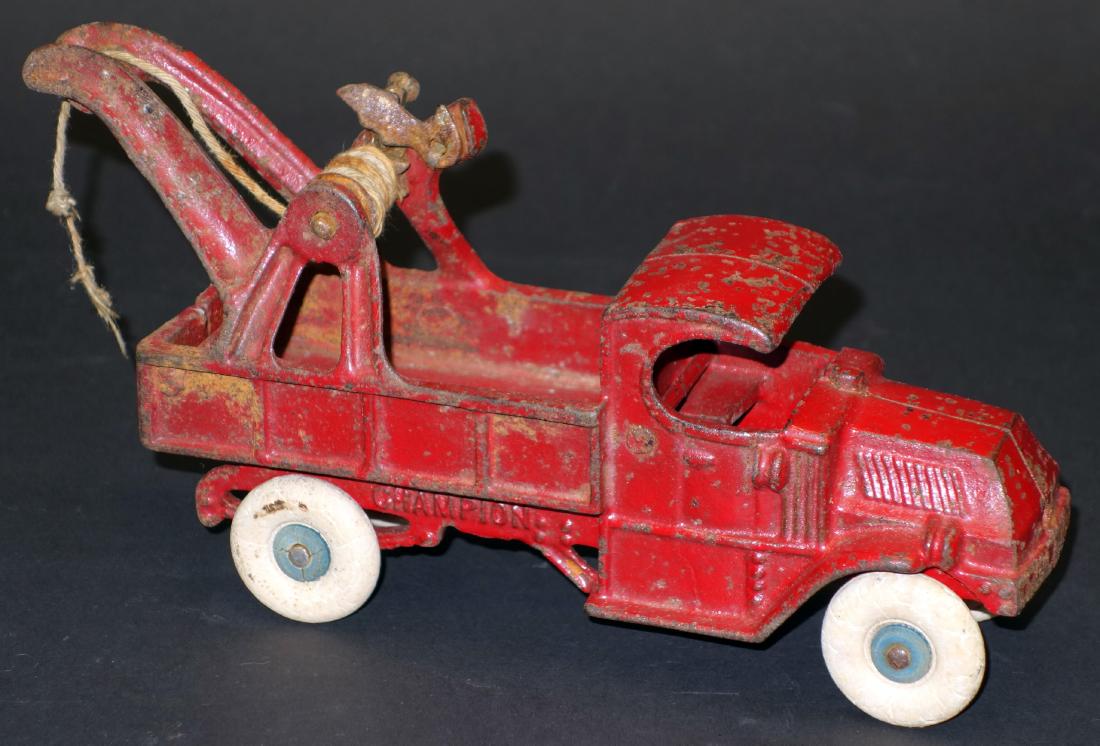 CHAMPION WRECKER: Painted cast iron; original paint; rust spots and paint chips; tires fatigued; L-8 1/2", F-G