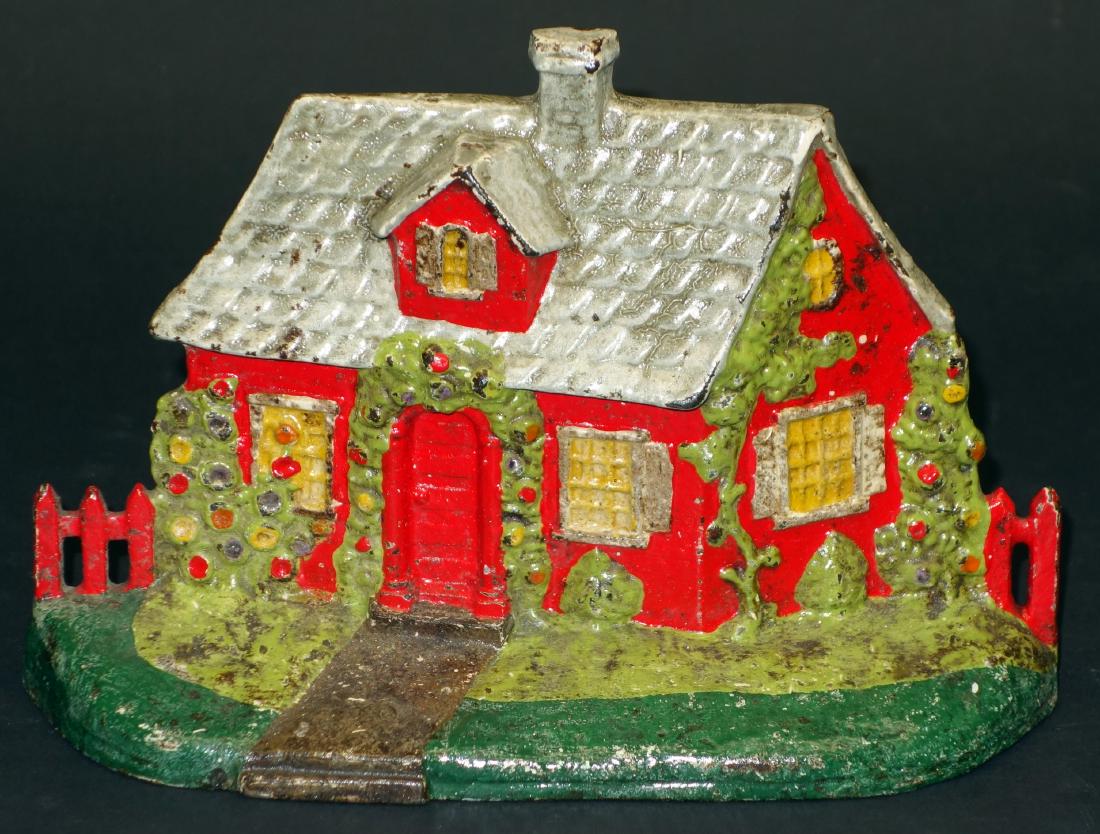 COTTAGE WITH FENCE DOORSTOP: Painted cast iron; Paint wear and chips, overcoated; L-8 1/2"; F-G