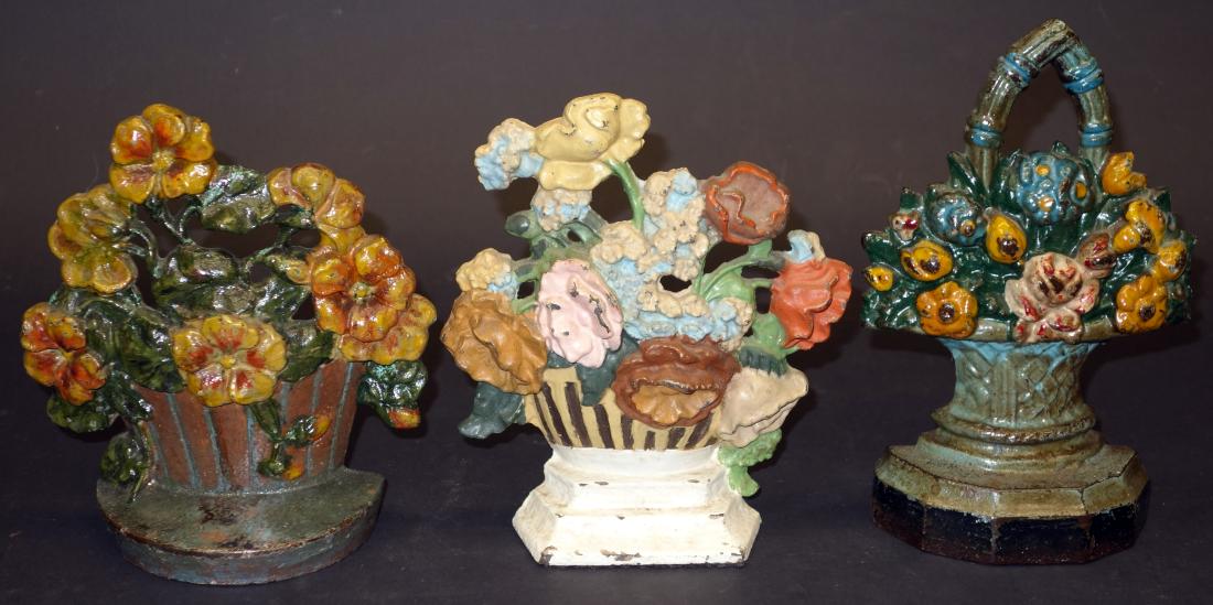 BASKETS OF FLOWERS DOORSTOPS - (3): Painted cast iron, repainted; H-7 1/2"-8"; F-G