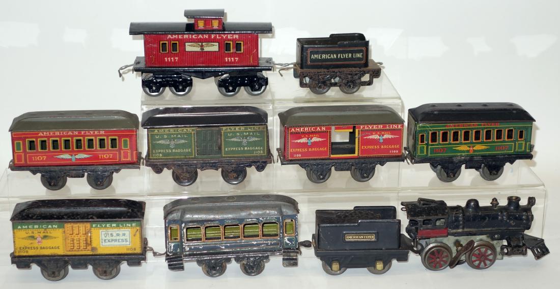 AMERICAN FLYER TRAINS: Painted cast iron engine; mechanical; working; no rods; together with tin litho (2) tenders and (7) cars; some rust and wear; L-56", F-G