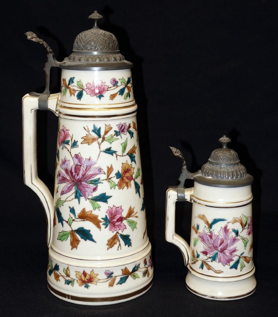 TANKARD STEIN & GERMAN STEINS (2): Ceramic with raised enamel floral decoration; (1) tankard-B.W. #420, (1) 1/2 L, B.W. #620; crazing; normal wear; H-8"-14 1/2", G