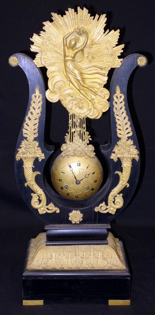 EMPIRE MANTLE CLOCK: Gilt bronze in wood frame, marked P. D. 4890; wound tight; wear; possibly missing small pieces; some veneer damage; H-25", G