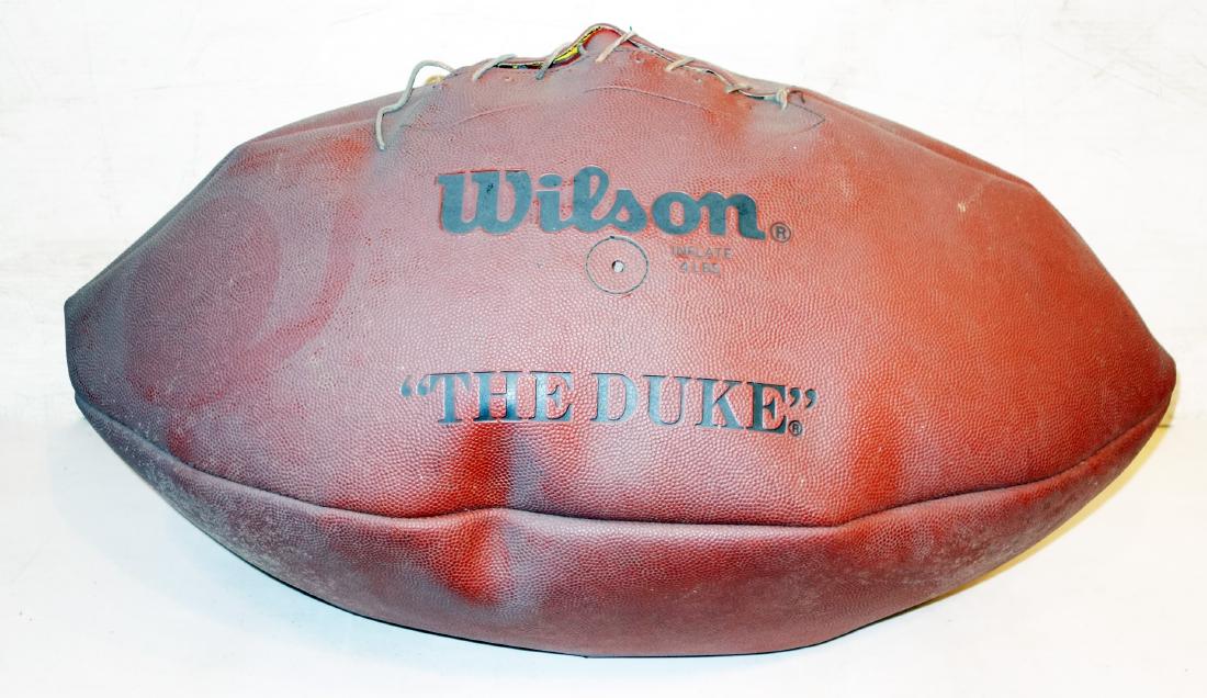 OVERSIZE FOOTBALL: "Wilson Duke", possibly leather; some wear; needs inflating and re-stitching; L-30", G