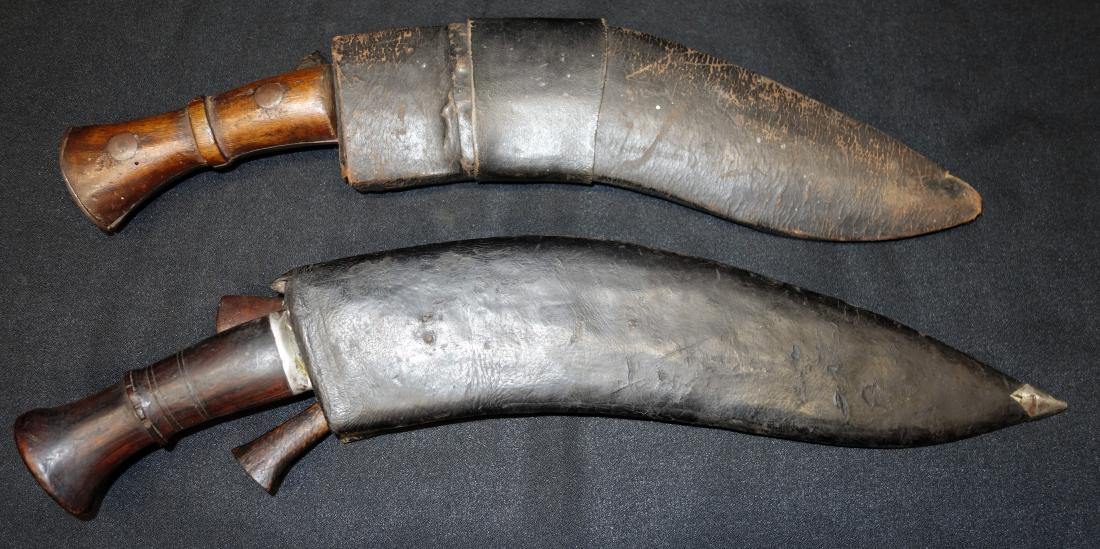 GURKHA KNIVES with SHEATHS (2): (1) WWI Bhojpure Nepal, scabbard with two smaller knives and (1) hook; 1917 saw service; (1) blade marked India with (1) smaller knife; blades L-12"-13"