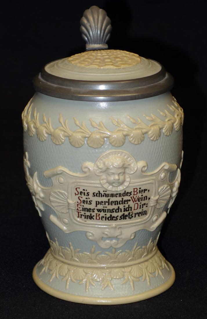 METTLACH STEIN (1/2 L): Relief cherub and shell shield with verse; shell and foliate trim; shell lid; #1727; H- 6 1/2"; EX-VG