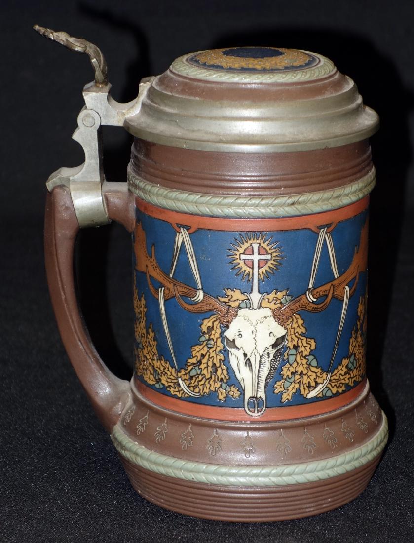 METTLACH STEIN (1/2 L): Known as St. Hurbert stein; incised with antler skulls; inlaid lid; #2813; H-7"; EX-VG