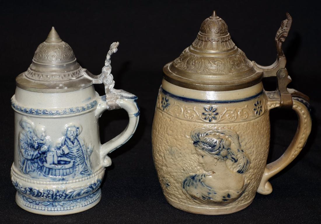 STONEWARE STEINS (2): Pewter lids; blue relief decoration; (1) portrait and verse; Whites N.Y.; (.5L); #41; (1) tavern scene and verse; (1/4 L ?); #35; H 6 1/2-7"; V-G