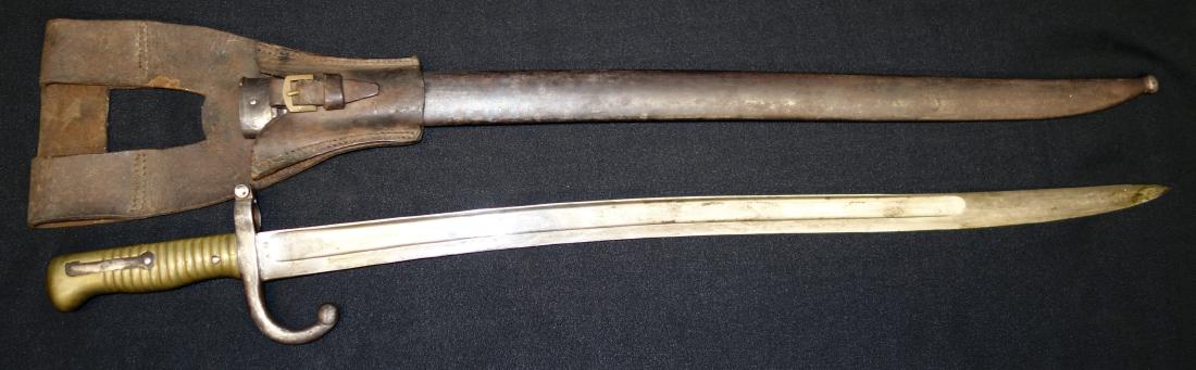 BAYONET: Brass handle; metal scabbard; touch marks on blade; original leather holster; old pitting on blade; L-28", F-G