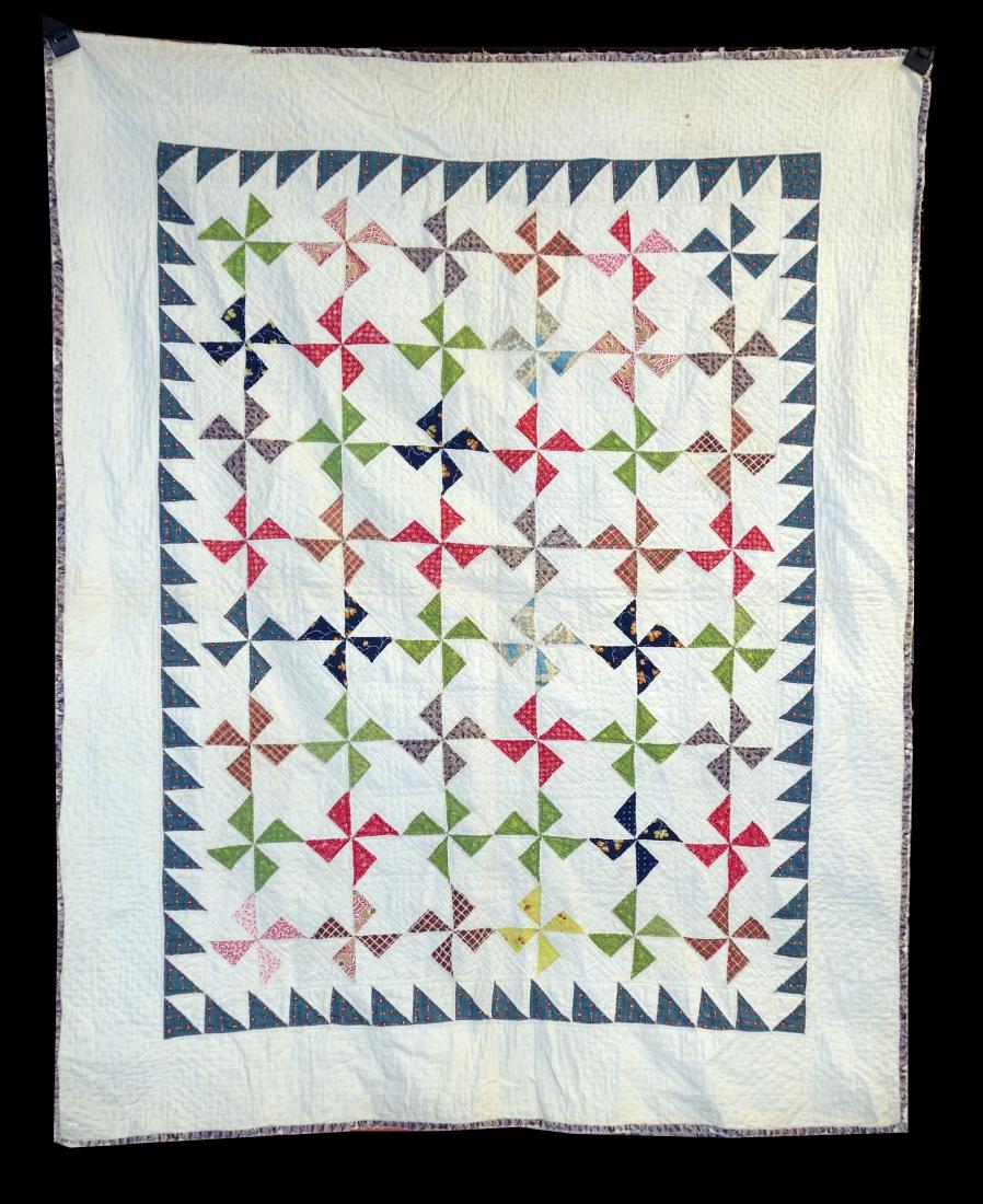 PINWHEEL CRIB QUILT: Vintage; triangle pattern; back quilted; edges frayed; minor stains; 43" X 34"; G
