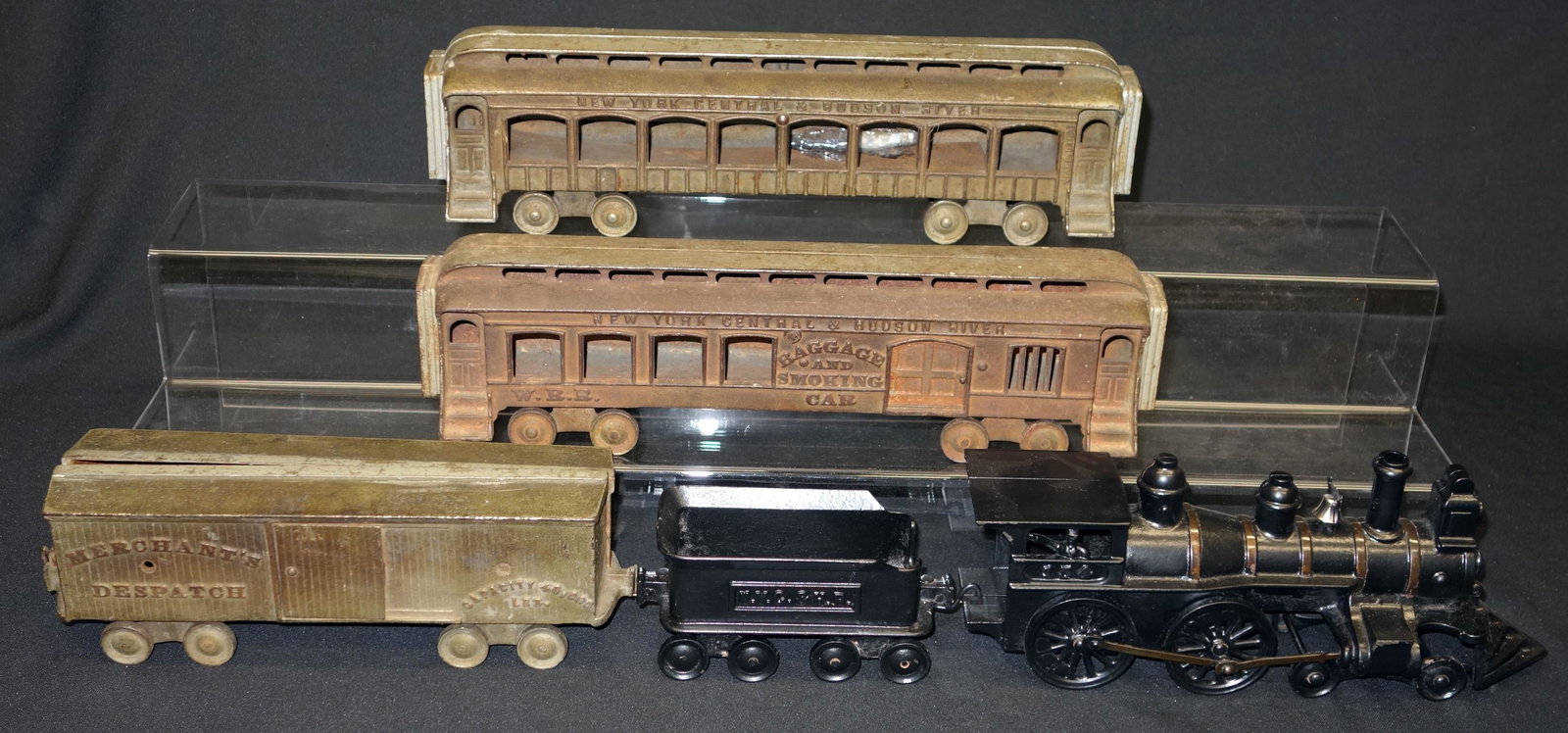 CAST IRON FLOOR TRAIN (5) PCS.: Painted cast iron; NY Central and Hudson River; possibly assembled; box car "Merchants Dispatch" is missing (1) sliding door; normal wear; L-60", F-G