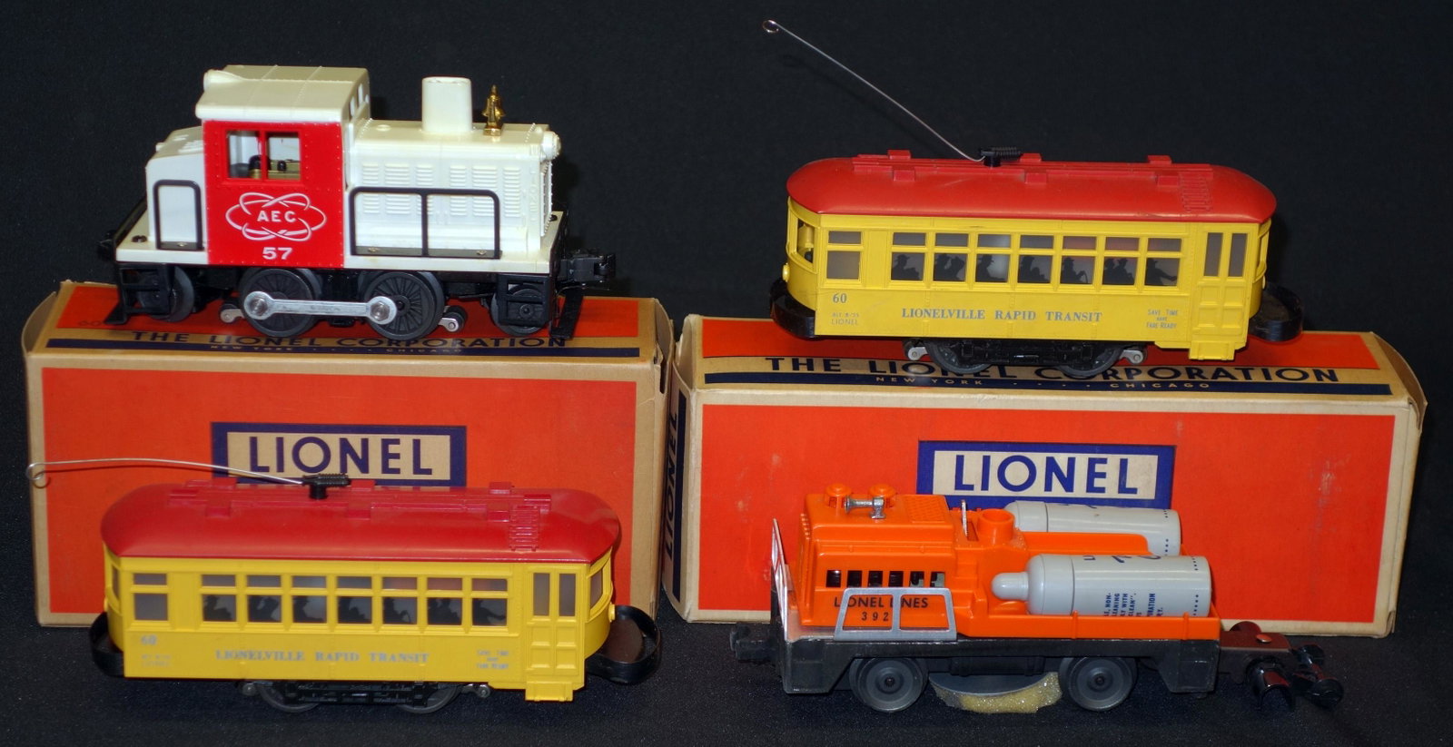 LIONEL TROLLEYS, ETC. (4): Original boxes; (2) #60 trolleys, (1) #3927 track cleaning car, (1) #57 AEC Switcher; boxes L-9"-10", EX-NM