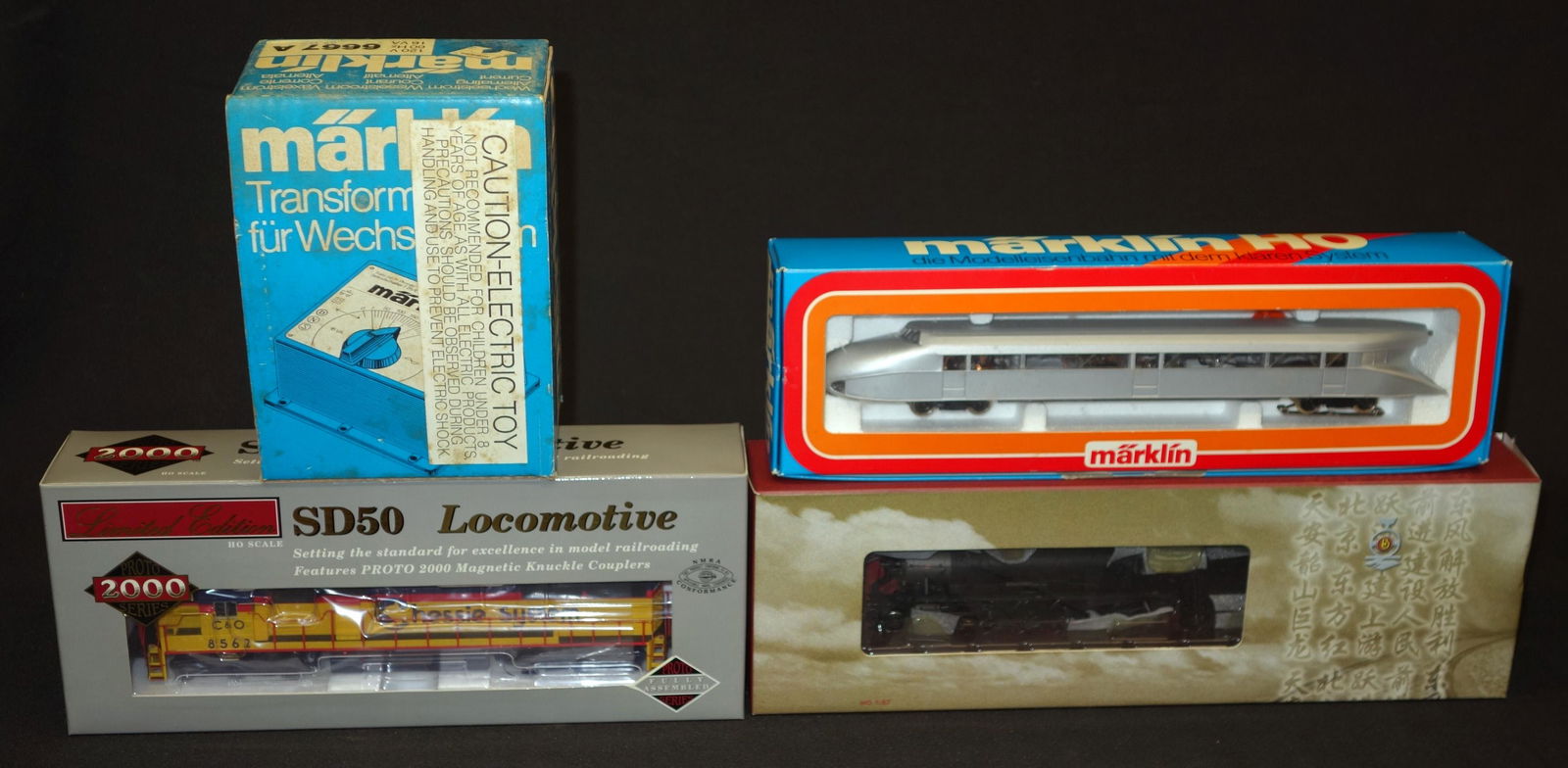 HO LOCOMOTIVES & TRANSFORMERS: (1) Marklin 3077 engine & 6667A transformer; (1) Proto 2000 SD 50 Locomotive, Chessie and C&O; (1) Bachmann 83201 Mikado; boxes L-12"-14", EX-NM