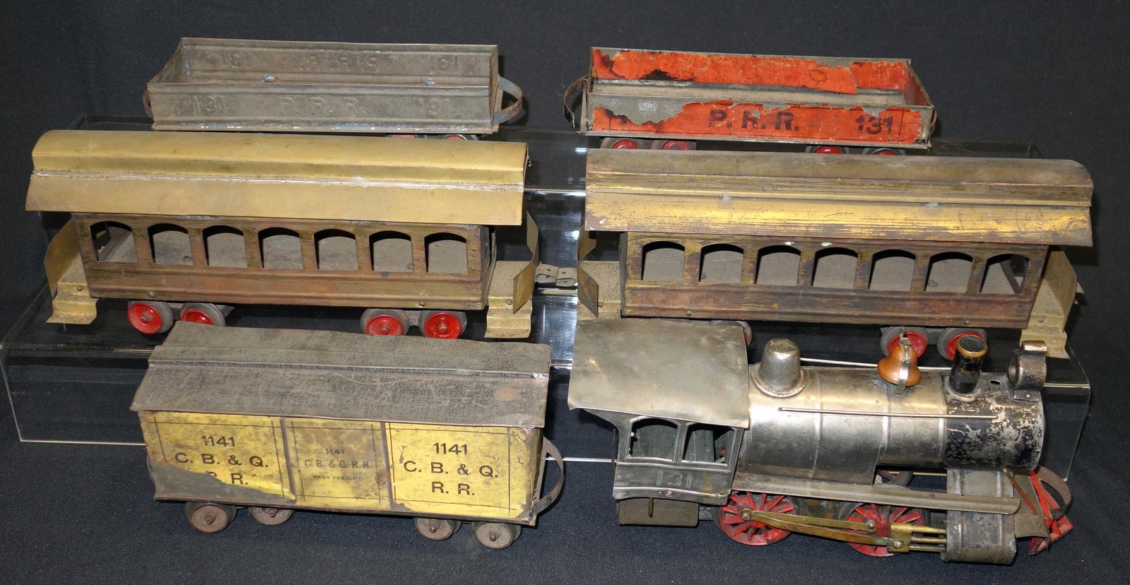 CARLISLE & FINCH TRAIN: Electric; painted tin and wood; (1) #131 engine, (2) #131 P.R.R. gondolas with one having paper litho ; (2) passenger cars; (10 #1141 box car, paper litho C.B.& O. railroad; wear, fading, some losses;