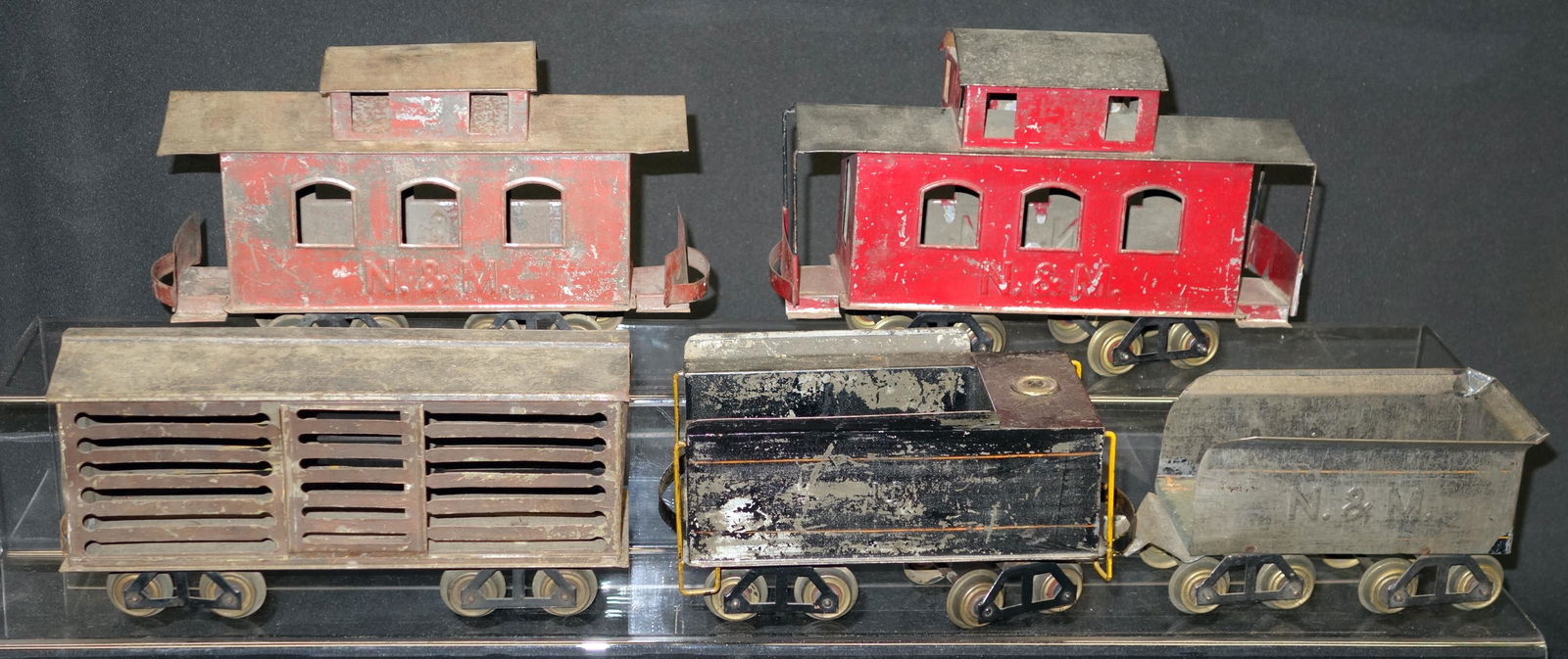 VOLTAMP TRAIN CARS (5): Painted tin; (1) #131 tender; (1) N&M tender; (2) N&M caboose; (1) cattle car; wear; L-8"-10", F-G