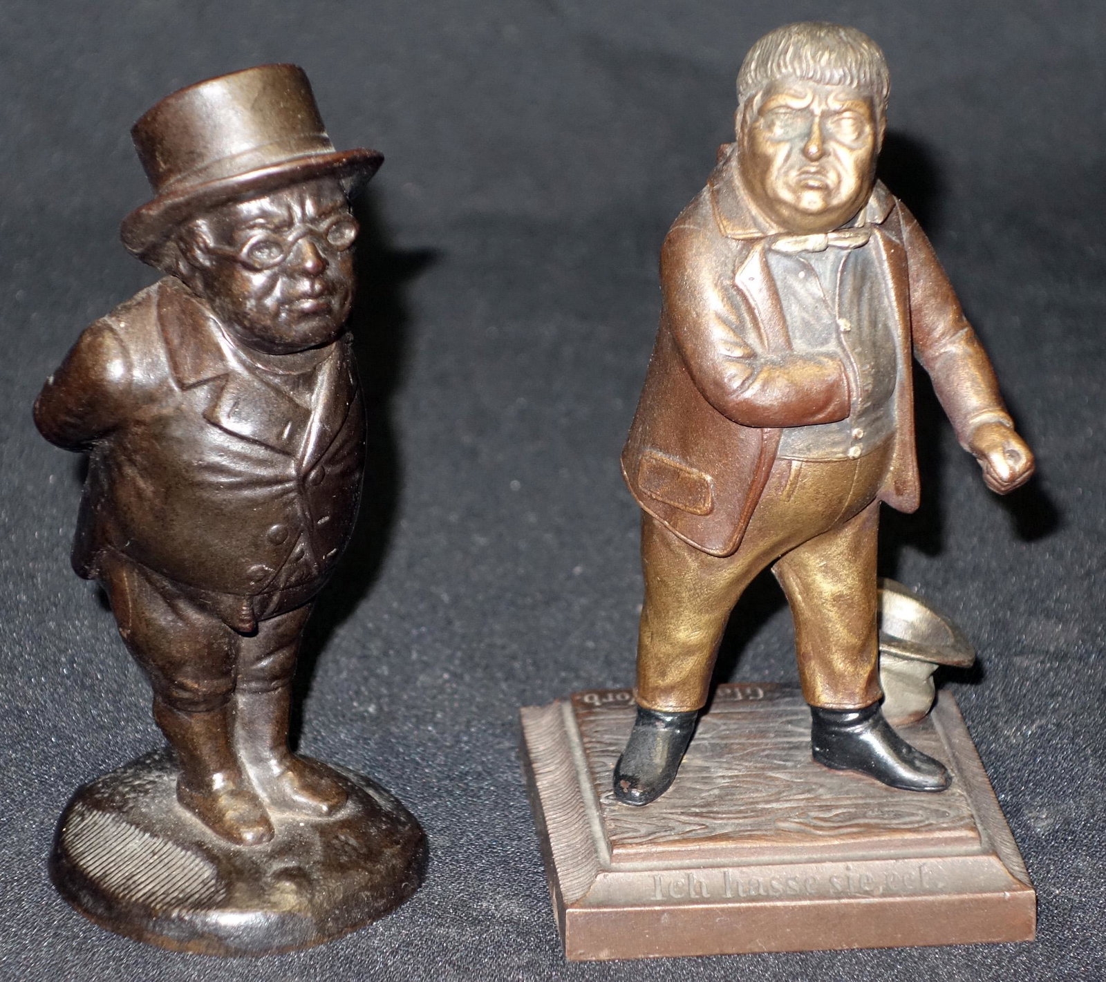 FIGURAL MATCH SAFES (2): Portly gentlemen; patinated cast iron; (1) man wearing top hat: Zimmermann, not hinged; (1) man with hand in vest: hinged, possibly held something in hand; H-5", G-VG