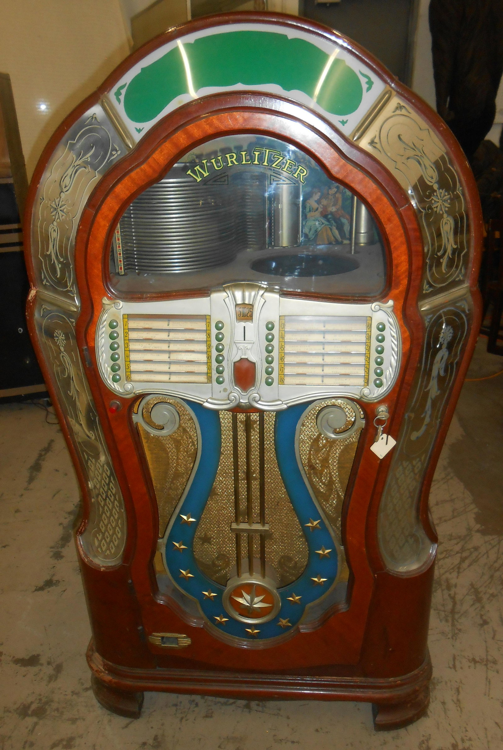 WURLITZER "MAE WEST" JUKEBOX: Wood case; metal and reverse inserts; (24) selections; plays two sizes, 78's and 45's; extra mechanism; works; several small cracks; wear; H-59", W-34", G