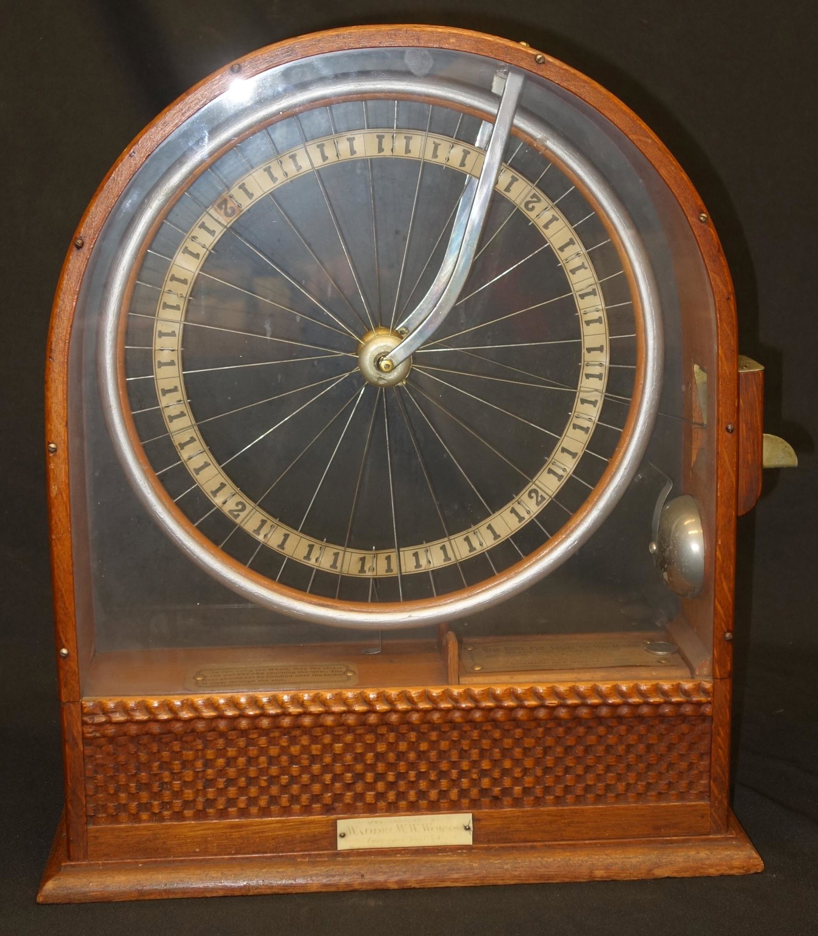 WADDEL WORKS COIN-OP WHEEL: "The Best 5 Cent Cigar in the house" label; oak case; paper litho in spoke wheel; (2) original instruction labels; original manufacture label; original finish; missing coin trap door on reverse; H-20"
