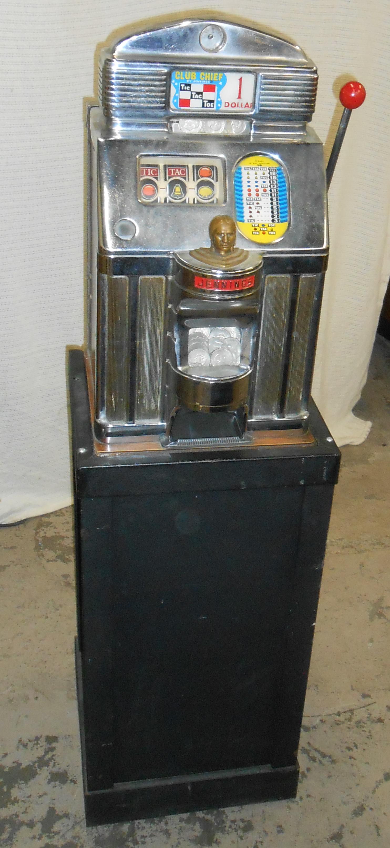 JENNINGS CLUB CHIEF SLOT MACHINE: $1, Chrome plated with wood case; comes with locking metal stand; working; light pitting and blemishes; normal wear; slot: H-27", W-15"; overall H-63", G-VG