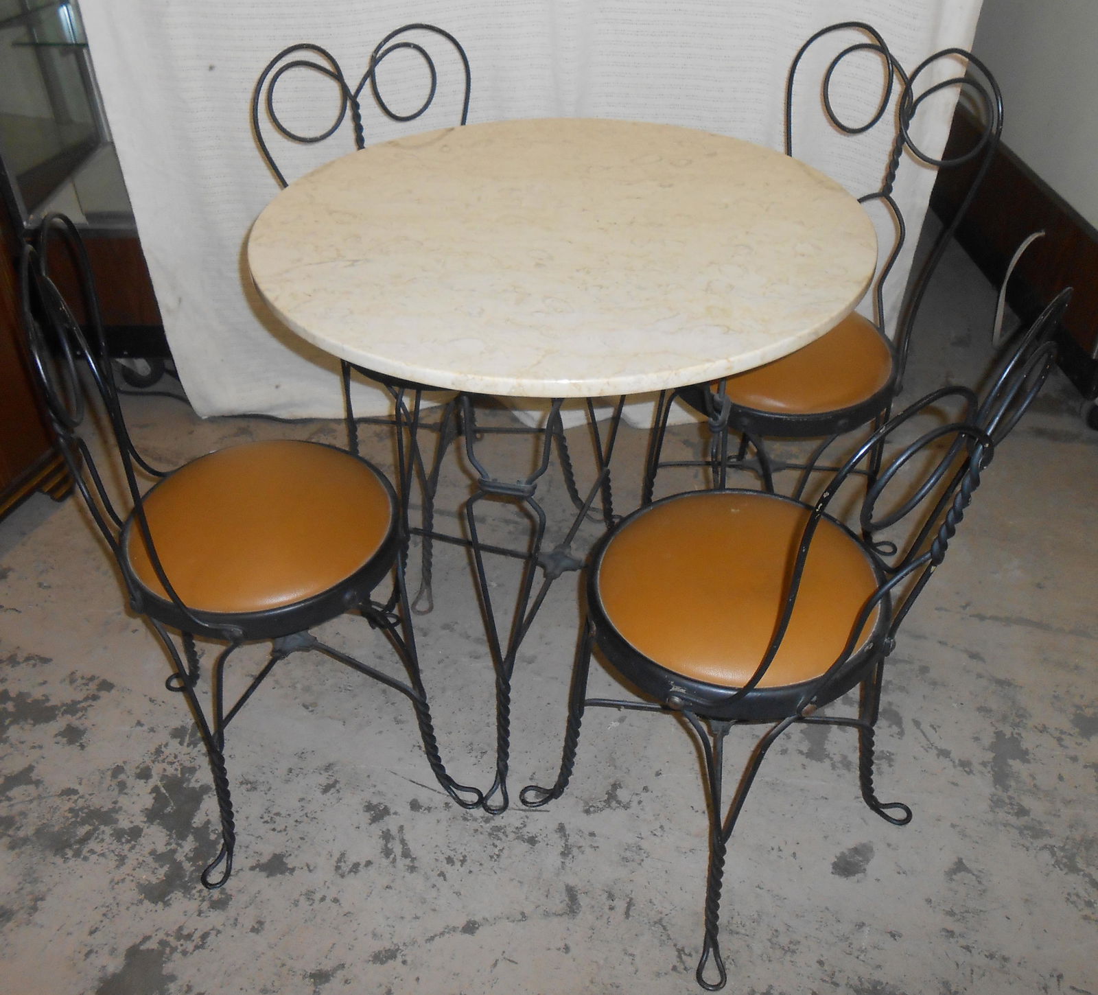 WIRE SODA FOUNTAIN TABLE & CHAIRS: Marble top (possibly replaced) table with (4) chairs; normal wear; recovered seats; Dia.-31", H-31", G-VG