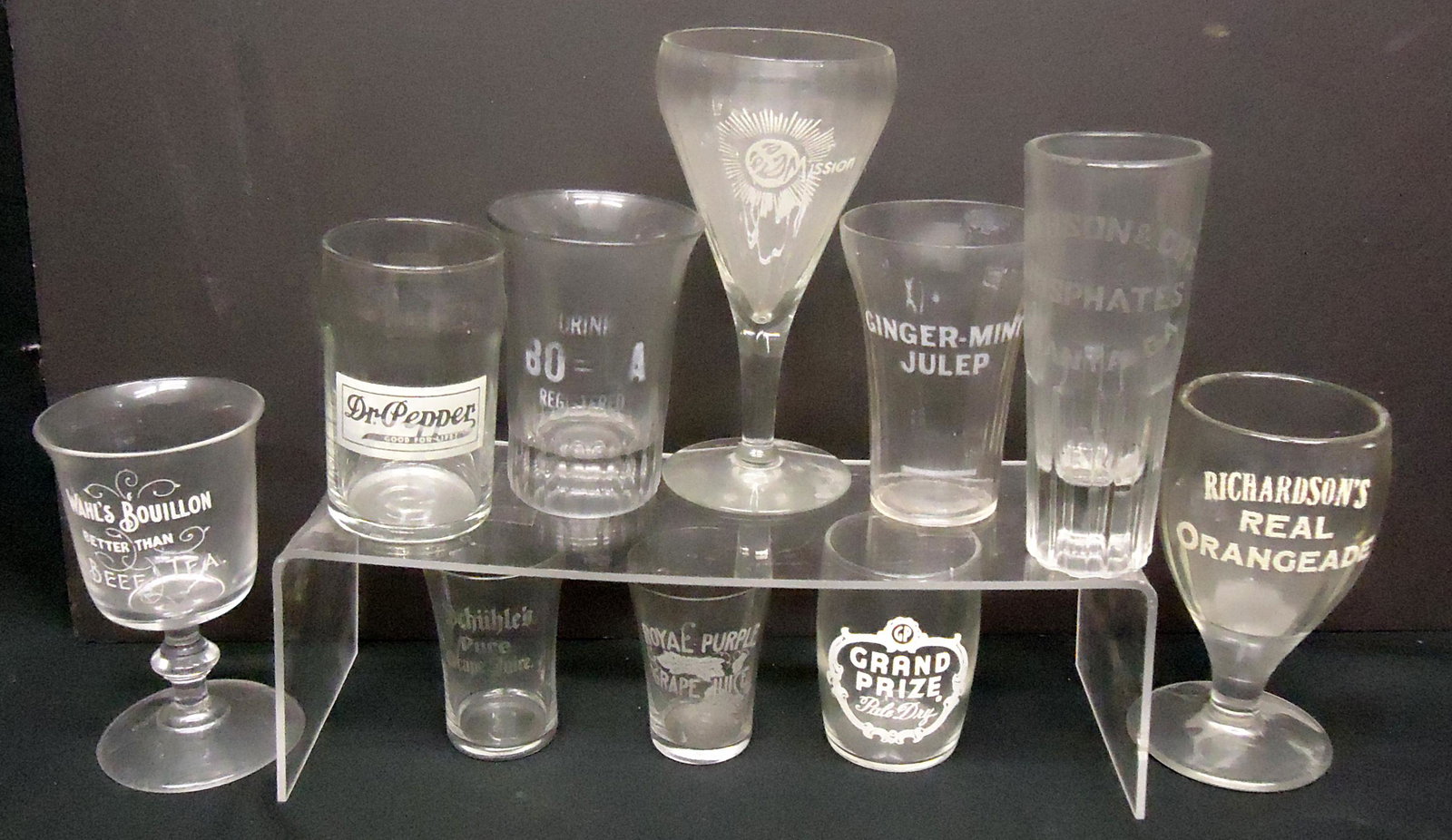 SODA FOUNTAIN ADVERTISING GLASSES (10): Etched and applied lettering; (2) small grape juice; (1) Dr. Pepper; (1) Ginger Mint Julep; (1) Anderson Phospates; (1) Bo-La; (1) Mission; (1) Richardsons Real Orangeade; (1) Wahl's Bouillon Tea; (1)